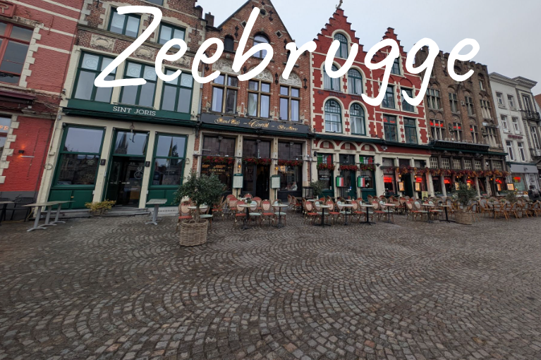 Colourful historic buildings in Bruges with outdoor seating on cobblestone street.