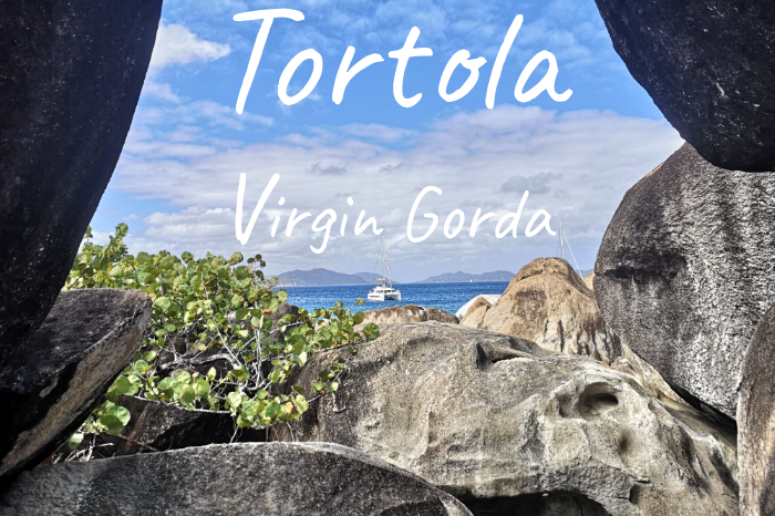View of the sea at Virgin Gorda through rocky formations and greenery.