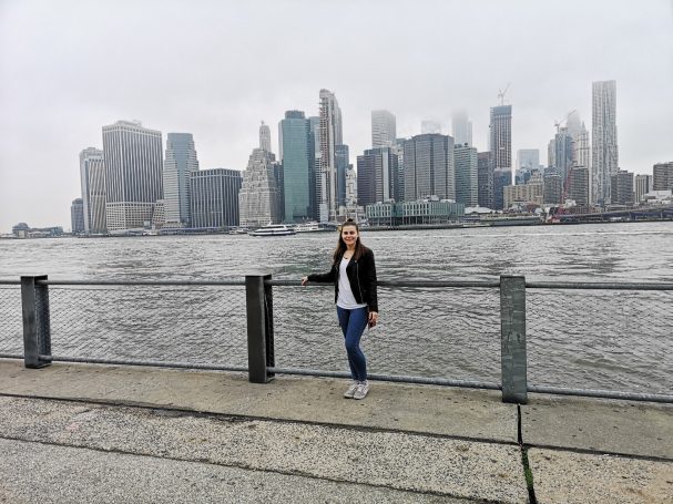 I&B's Founder posing in Brooklyn NY with the Manhattan skyline in the background, across the river.