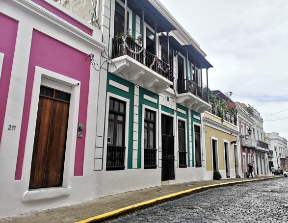 Colourful colonial buildings along a cobblestone street in a historic area of San Juan, Puerto Rico.