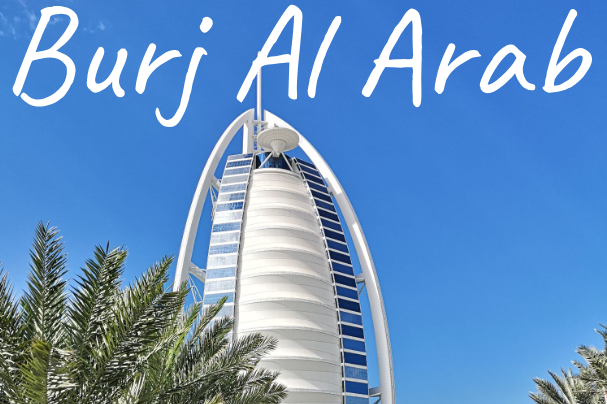 The Burj Al Arab, a luxury hotel in Dubai, set against a clear blue sky.
