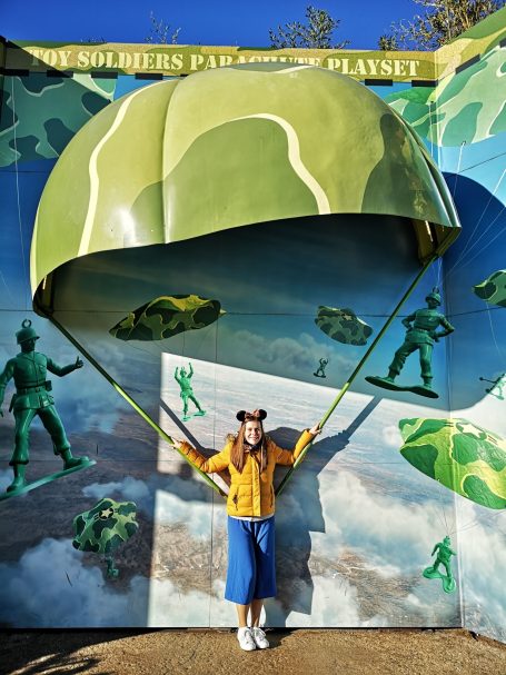 I&B's Founder posing with a large green parachute, in the Toy Story area of the Disneyland Paris Resort