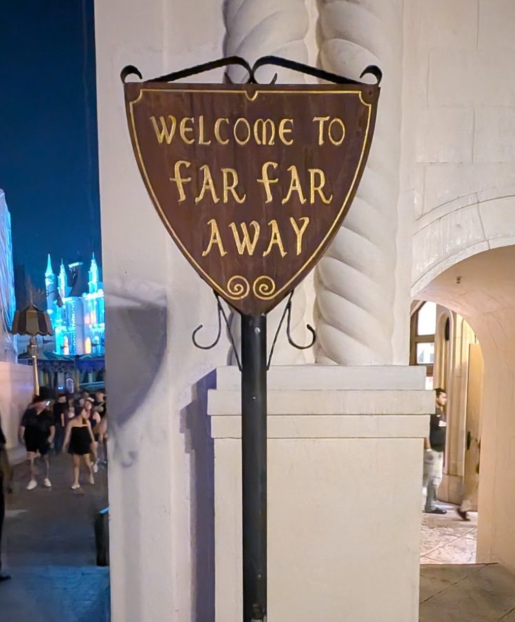 Signpost reading "Welcome to Far Far Away" against a lit background.