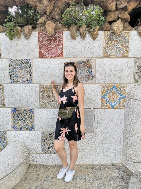 I&B's Founder posing in front of a tiled wall in Park Güell in Barcelona.