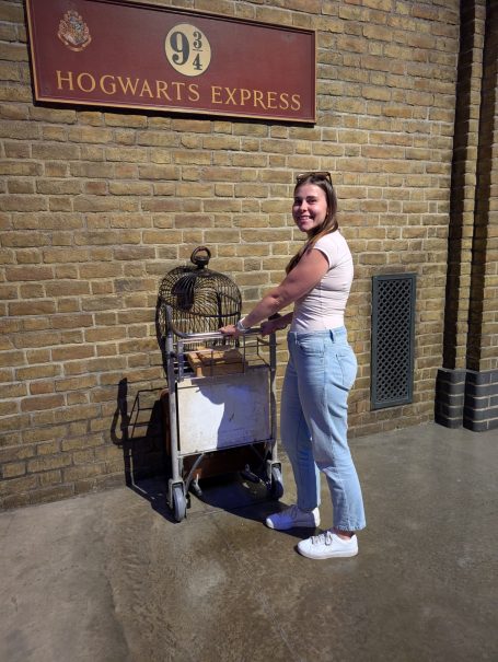 I&B's Founder posing with a luggage trolley on platform 9 and 3 quarters at Warner Bros the making of Harry Potter in London