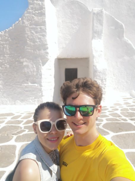 I&B's Founder and Husband posing in front of the Church of Panagia Paraportiani in Mykonos.