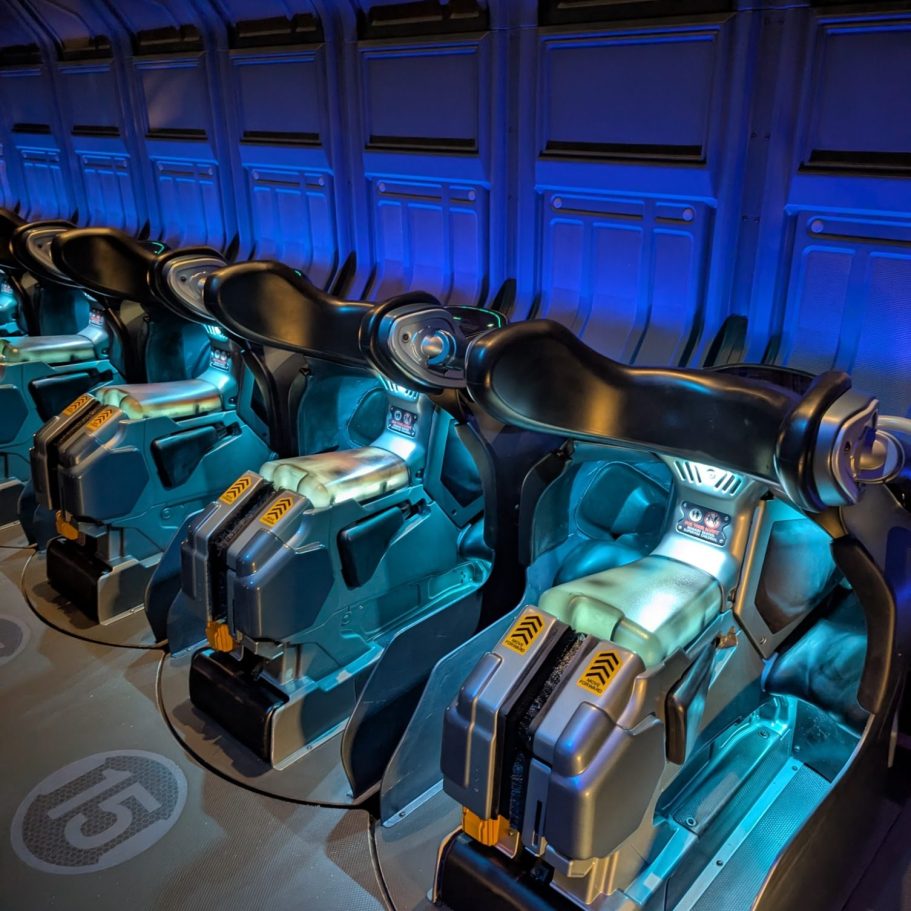 Futuristic seating pods with blue lighting in a high-tech environment.