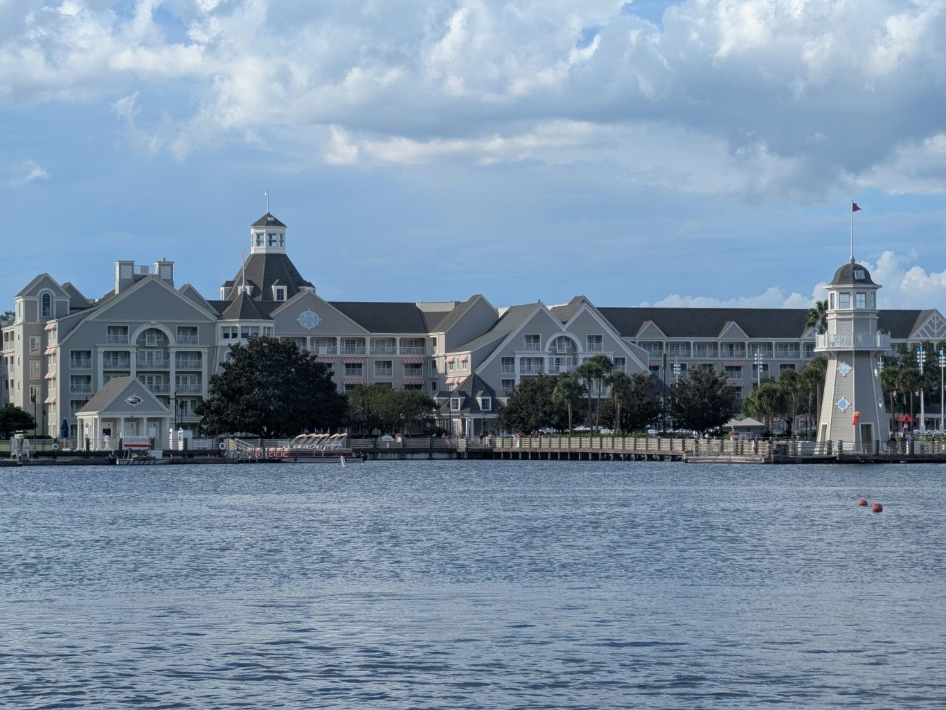 Coastal hotel with architectural detailing, near water, under a cloudy sky.