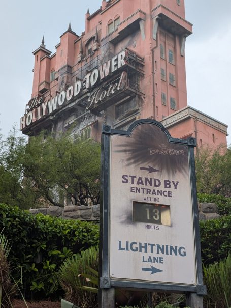 Hollywood Tower sign with entrance information for Standby and Lightning Lane.