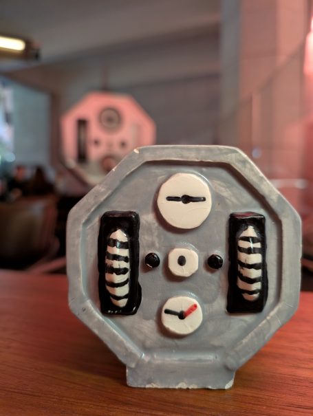 Close-up of a vintage control panel with dials and buttons.