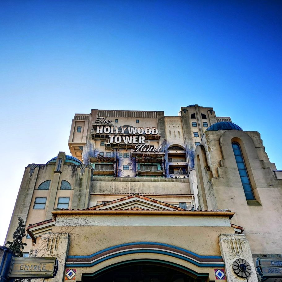 A tall, ornate building with a prominent sign reading "Hollywood Tower" against a clear blue sky.