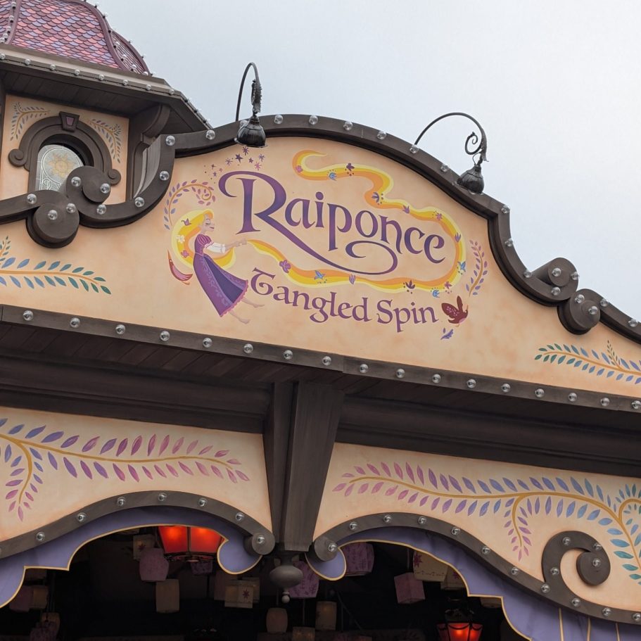 Signage for "Rapunzel's Tangled Spin" attraction with decorative elements.