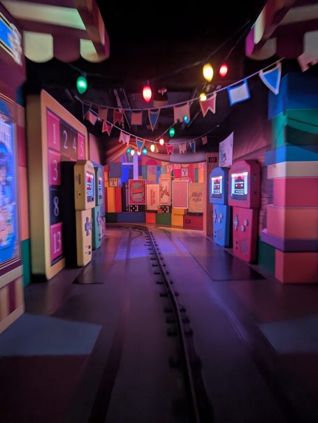 Colourful corridor with whimsical decorations and vibrant lights.