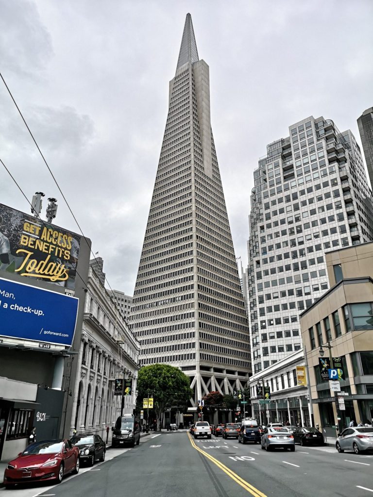 Transamerica Pyramid towering above buildings on a cloudy day in San Francisco.