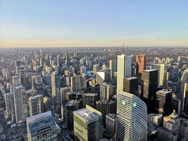 Panoramic view of Toronto skyline with tall buildings under a clear sky.