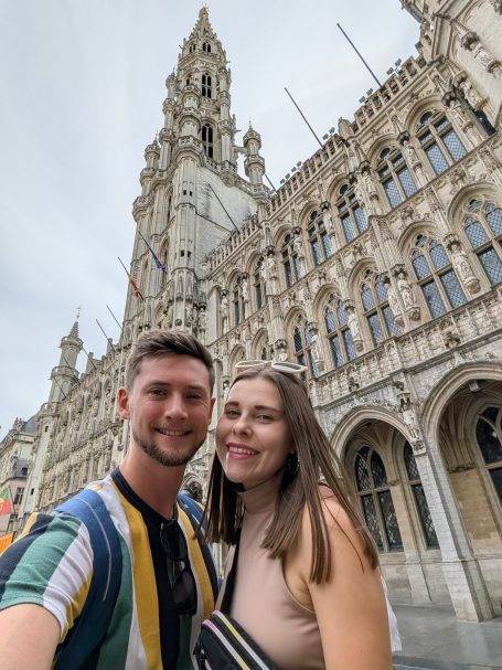 I&B's Founder & Husband posing in front of the Brussels Town Hall, located in the Grand Place in Brussels.