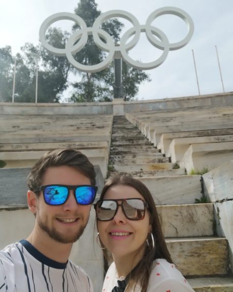 I&B's Founder & Husband posing in front of the Olympic rings at the Panathenaic Stadium in Athens