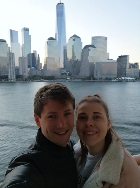 I&B's Founder & Husband posing on the cruise ship balcony with the New York Skyline in the background.