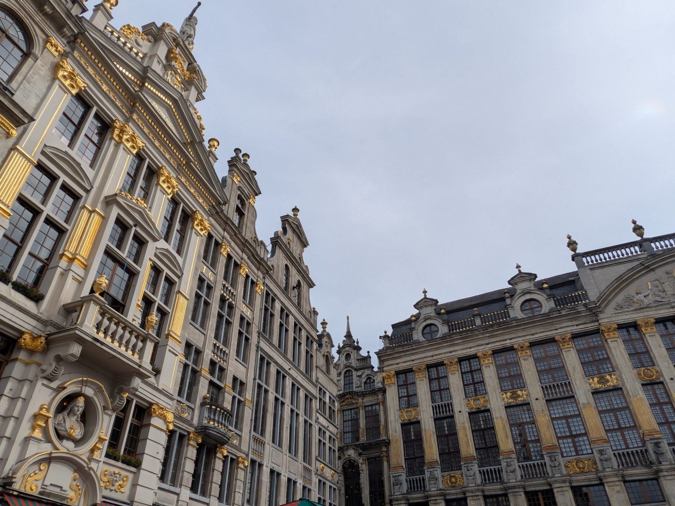 Historic buildings with ornate architecture under a cloudy sky.