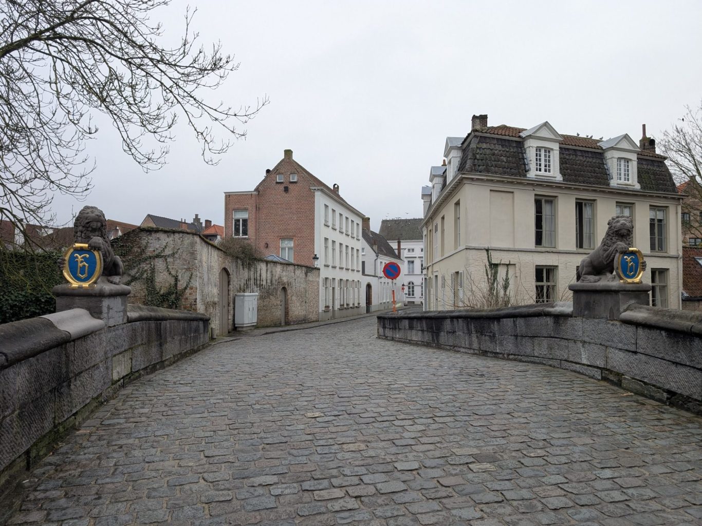 Lion Bridge leading to residential buildings under a cloudy sky.
