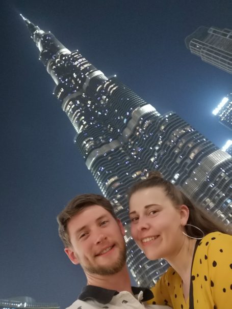 I&B's Founder & Husband posing in front of the Bruj Khalifa, which is illuminated as it is a nighttime setting