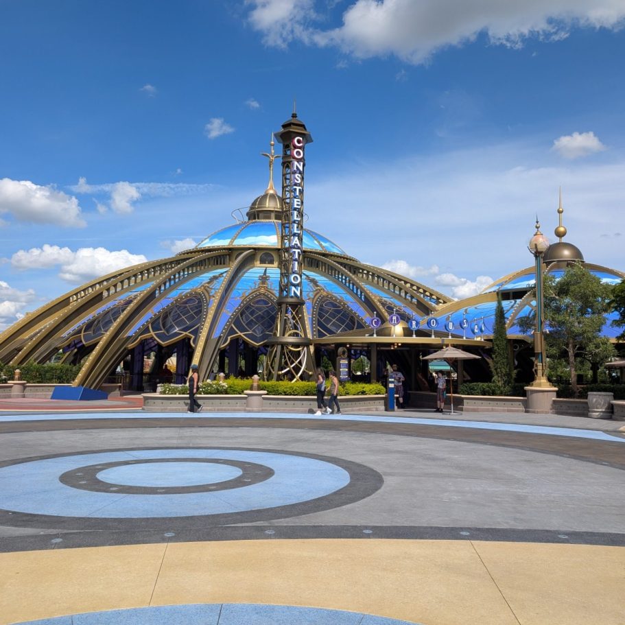 Metal structure with a blue and gold dome, surrounded by a circular walkway and blue sky.