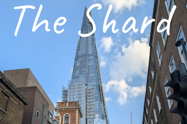 The Shard skyscraper rising against a blue sky with white clouds.