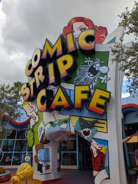 Sign for Comic Strip Café featuring colourful cartoon characters and vibrant graphics.