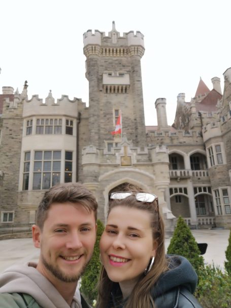 I&B';s Founder & Husband posing in front of the exterior of Casa Loma in Toronto.