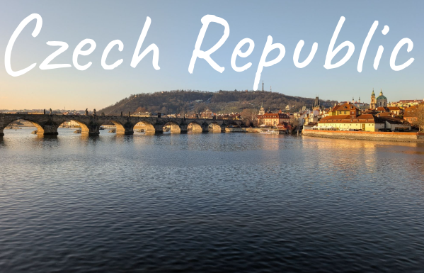View of the Vltava River in Prague with the Charles Bridge and cityscape.