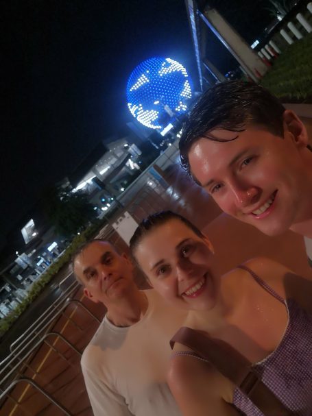 I&B'S Founder, Husband & Dad posing in the rain in front of the ride spaceship Earth at EPCOT