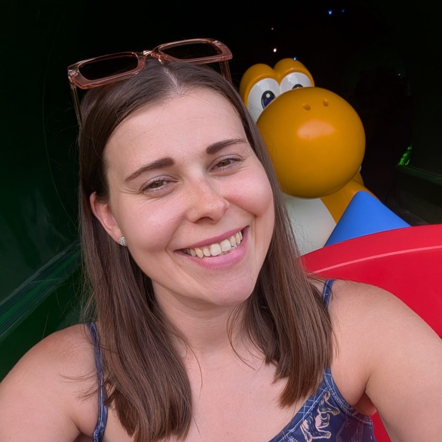 I&B's Founder poses with a cartoon dinosaur figure in the background.