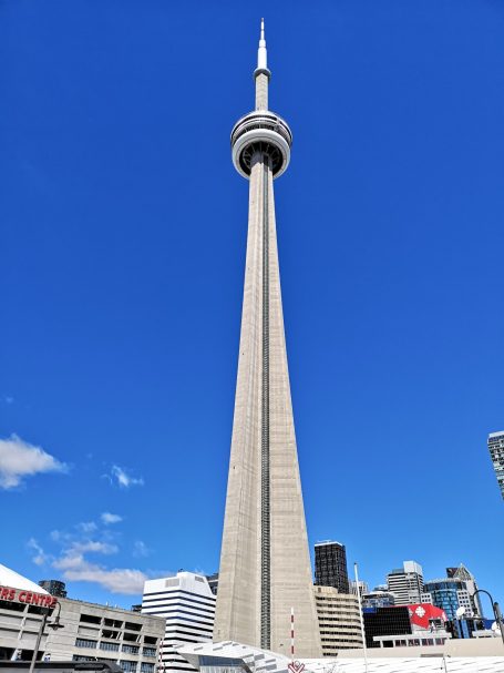 The CN Tower against a clear blue sky, showcasing its iconic height and structure.