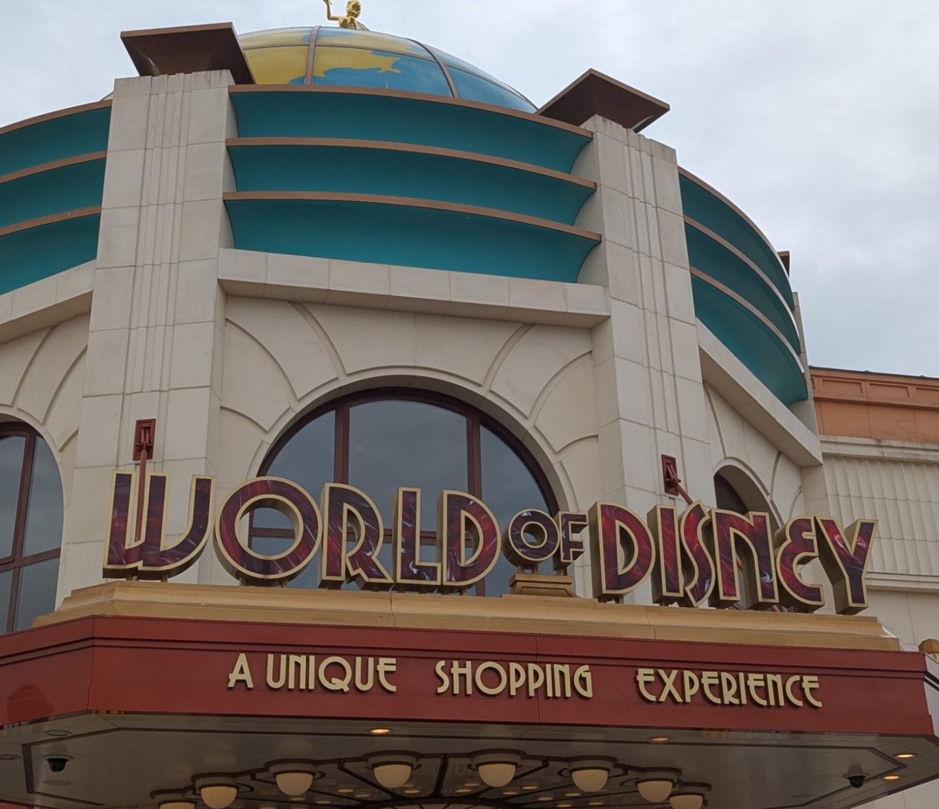 World of Disney store entrance featuring a globe on the roof and unique shopping signage.