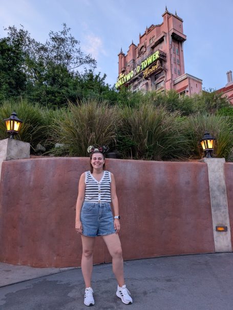 I&B's Founder posing in front of the Hollywood Tower Hotel in Disney's Hollywood Studios