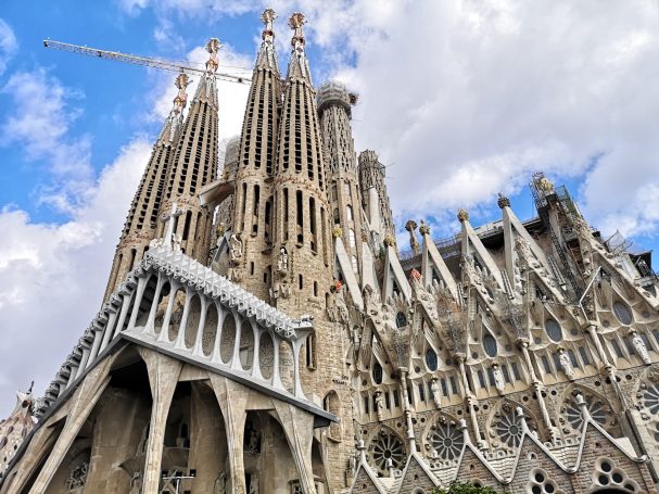 The intricate façade of the Sagrada Família, featuring towers and detailed architecture.