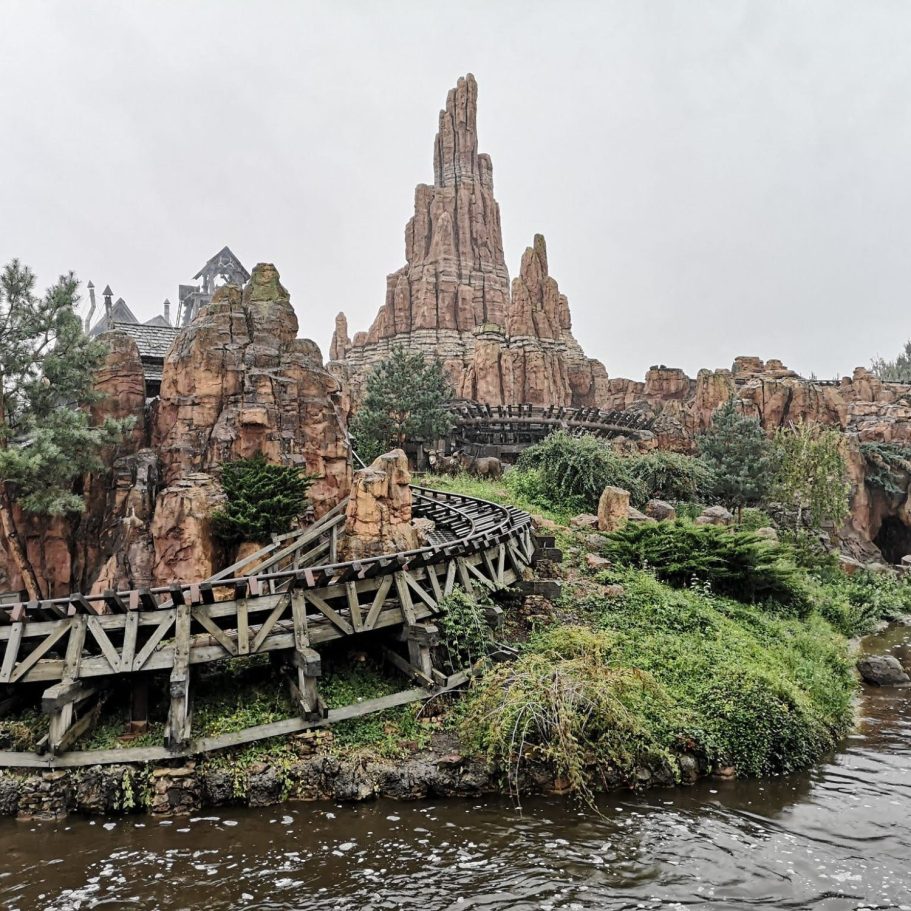 Scenic view of rocky cliffs and a winding path in a theme park setting.