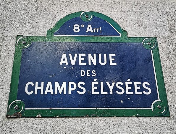 Blue street sign for Avenue des Champs-Élysées in the 8th arrondissement in Paris.