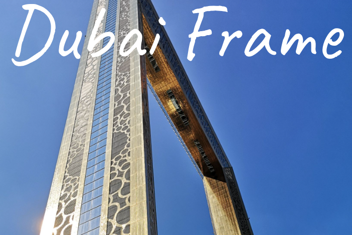 Tall, modern structure known as the Dubai Frame against a clear blue sky.