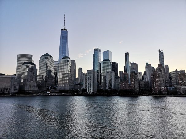 Skyline of New York City with One World Trade Center and waterfront view.
