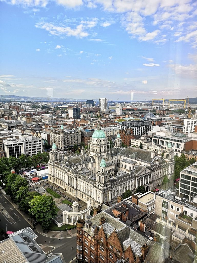 Panoramic view of Belfast city skyline featuring a historic building with a green dome.
