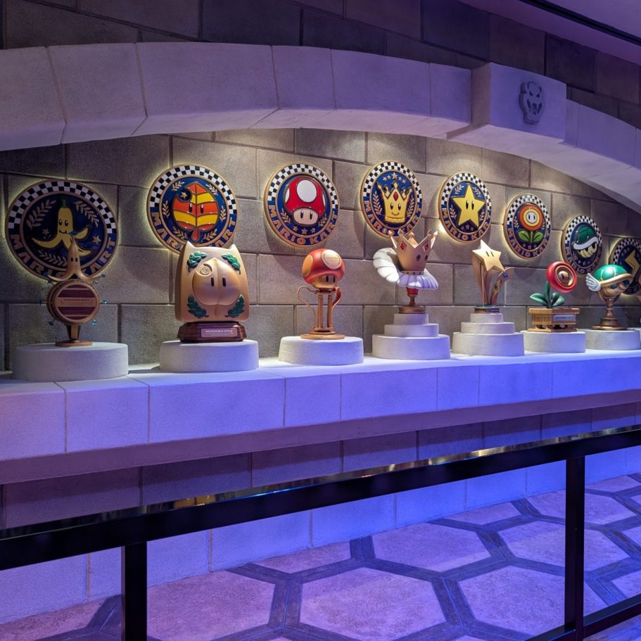 A row of decorative trophies and emblems displayed on a wall.