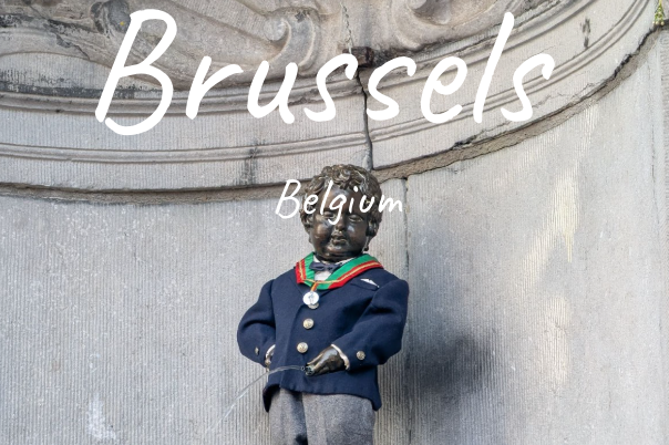 Statue of a small boy in a blue suit, located in Brussels.