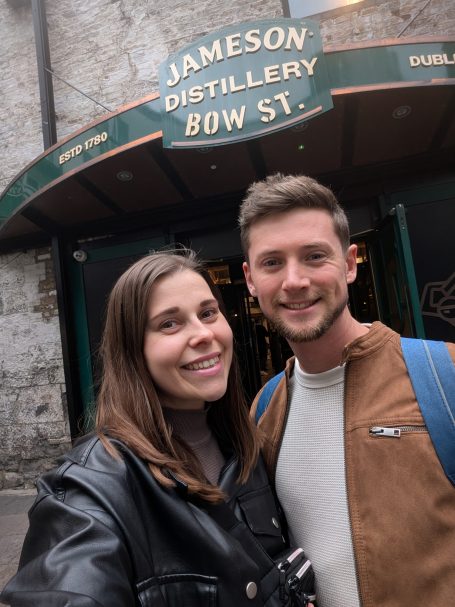I&B's Founder and Husband posing in front of the Jameson Distillery on Bow Street in Dublin