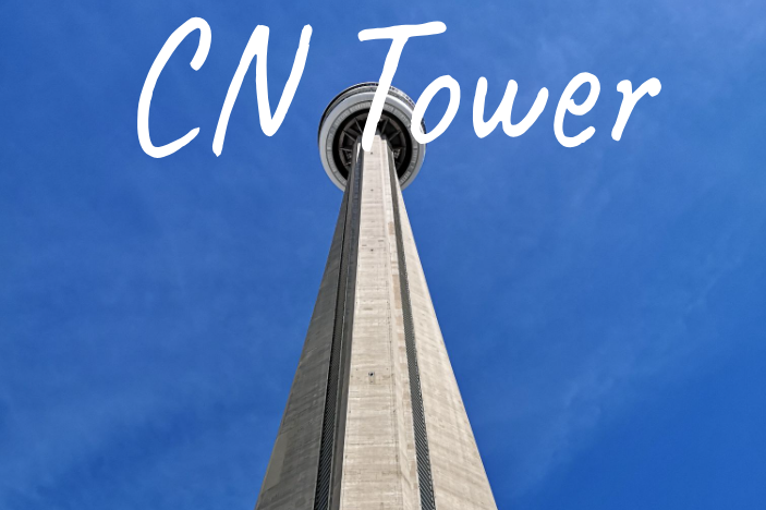 View of the CN Tower from below against a clear blue sky.