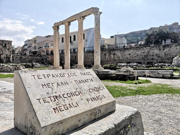 Ruins of a temple with stone columns and a marble inscription at Hadrian's Library in Athens