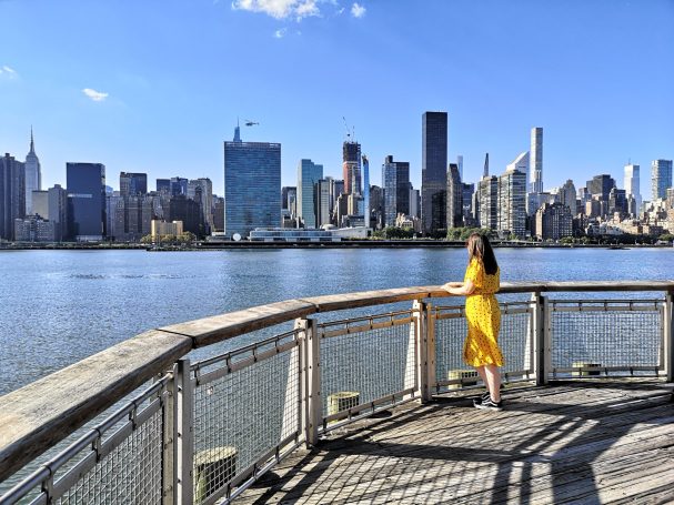 I&B's Founder posing in Gantry Plaza State Park in NY with the Manhattan Skyline in the background over the river.
