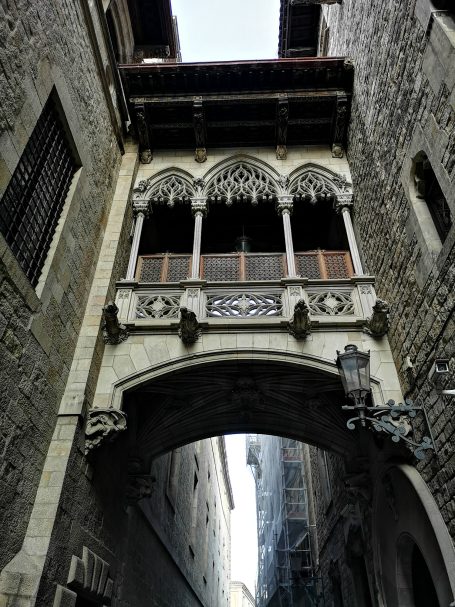 Pont del Bisbe, a gothic-style bridge extending over a narrow street with stone buildings.