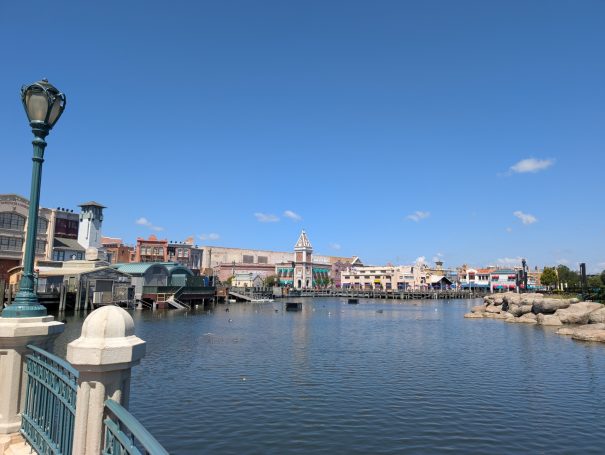 Waterfront view of a city with buildings and boats under a clear blue sky.