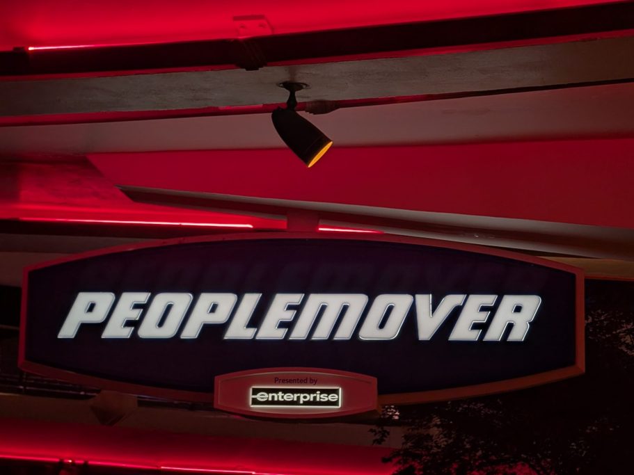 Sign displaying the word "PEOPLEMOVER" in a vibrant, illuminated style.